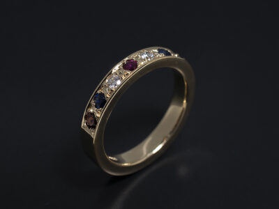 Ladies Half Eternity Ring, 18kt Yellow Gold Pavé Set Design, Round Garnet, Round Brilliant Cut Sapphire (2), Round Brilliant Cut Diamonds (2), F Colour, SI Clarity Minimum