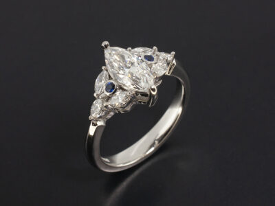 Ladies Diamond and Sapphire Engagement Ring, Platinum Claw Set Design, Marquise Cut Diamond 0.70ct, E Colour, SI1 Clarity, Marquise Cut Diamond Side Stones 0.34ct Total, Round Brilliant Cut Sapphires x2
