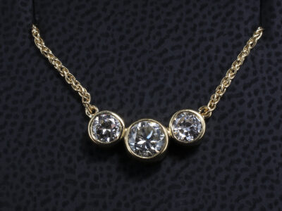 18kt Yellow Gold Rub over Set Diamond Trilogy Pendant, Customers own Round Brilliant Cut Diamonds 0.40ct and 0.50ct (2)