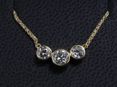 18kt Yellow Gold Rub over Set Diamond Trilogy Pendant, Round Brilliant Cut Diamonds 0.40ct and 0.50ct (2)