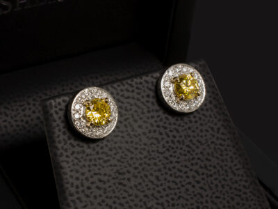 Platinum and 18kt Yellow Gold Yellow Diamond Studded Earrings, Claw and Pavé Set Design, Round Brilliant Cut Yellow Treated Diamonds 0.47ct and 0.51ct, Round Brilliant Cut Diamond Set Halo 0.40ct Total, Locking Fittings
