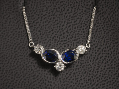 18kt White Gold Rub over Set Sapphire and Diamond Pendant, Oval Shaped Sapphires 2.17ct Total (2), Round Brilliant Cut Diamonds 0.60ct Total (3)
