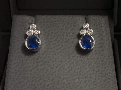 18kt White Gold Rub over Set Sapphire and Diamond Studded Earrings, Round Cut Sapphires 1.25ct Total (2), Round Brilliant Cut Diamonds 0.13ct Total (6)