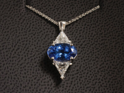 Platinum Claw Set Tanzanite and Diamond Pendant, Oval Cut Tanzanite 3.80ct, Trilliant Cut Diamonds 1.09ct Total (2), Spiga Chain