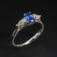 Ladies Sapphire and Diamond Trilogy Ring, Platinum Claw Set Lattice Design, Oval Cut Blue Sapphire 0.59ct, Pear Shaped Lab Grown Diamonds 0.24ct Total (2)