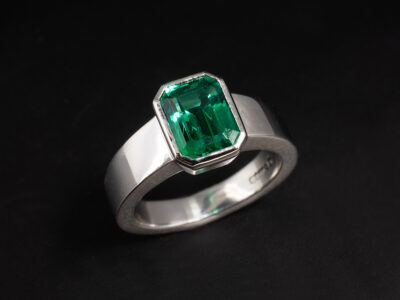 Ladies Solitaire Emerald Dress Ring, Platinum Rub over Set Design, Octagonal Cut Lab Grown Emerald 1.46ct, Inverted Taper Detail