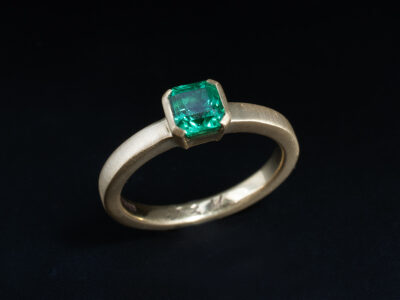 Ladies Solitaire Emerald Ring, 18kt Yellow Gold Partial Rub over Set Design, Octagonal Cut Square Emerald 0.73ct, Brushed Finish Detail