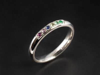 Ladies Multi Coloured Stone Eternity Ring, Platinum Pavé Set Court Shaped Design, Round Cut Dark Green Emerald, Light Green Emerald, Peridot, Cornflower Blue Sapphire, Pink Tourmaline, Ruby