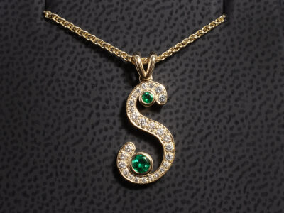 18kt Yellow Gold Initial S Diamond and Emerald Pendant, Rub over and Pavé Set Double Bale Design, Initial ‘S’ set with Round Cut Emeralds 0.14ct Total (2) Round Brilliant Cut Diamond approx. 0.13ct Total (26)