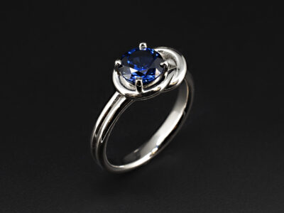 Ladies Blue Sapphire Solitaire Engagement Ring, Platinum Claw Basket Set Reef Knot Design, Round Cut Lab Grown Sapphire 1.58ct
