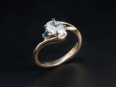 Ladies Diamond and Blue Topaz Twist Engagement Ring, Platinum and 18kt Rose Gold Claw Set Design, Oval Cut Lab Grown Diamond 0.73ct, Round Cut London Blue Topaz 0.03ct