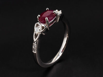 Ladies Ruby and Diamond Engagement Ring, Platinum Claw and Pavé Set Design with Triquetra Shoulders, Oval Cut Ruby 1.20ct, Round Brilliant Cut Diamond Shoulders